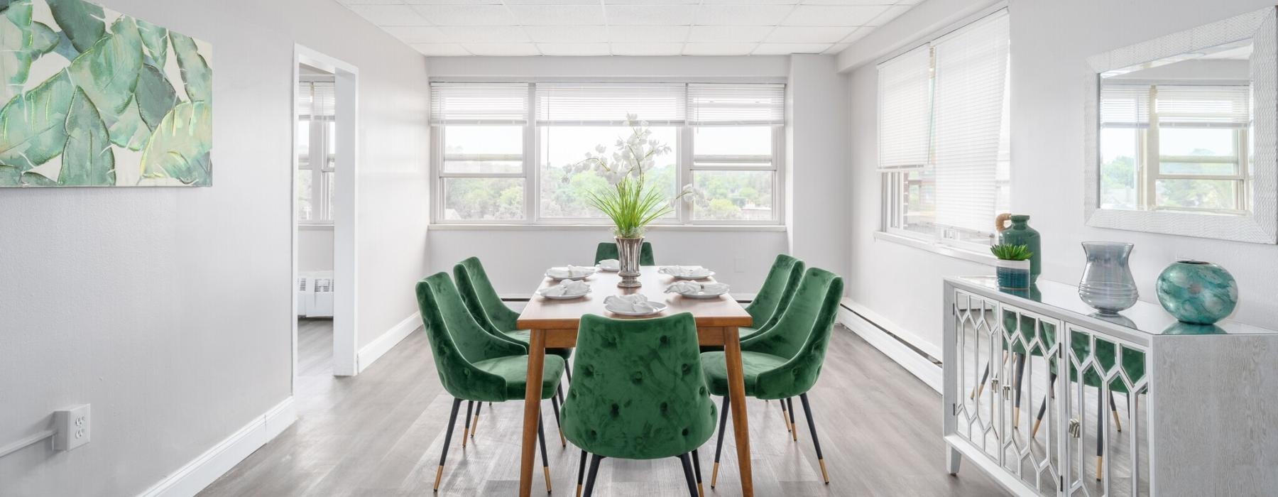 a dining room with green chairs