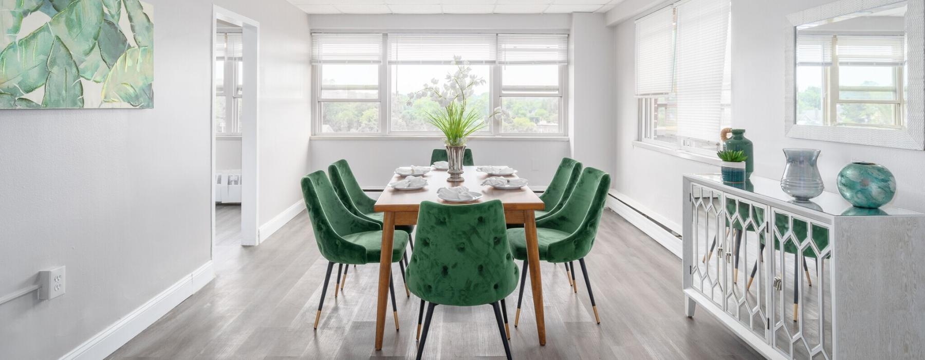 a dining room with green chairs