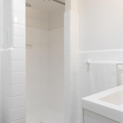 Spacious bathrooms with everything you need a bathroom with a sink and a shower unit