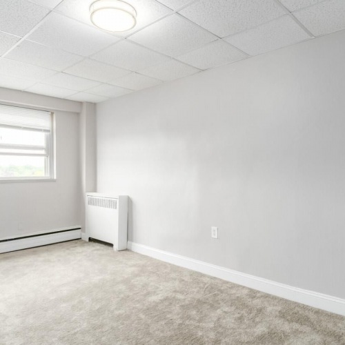 Settle into comfort at Bryn Mawr Suites a room with a window and a light